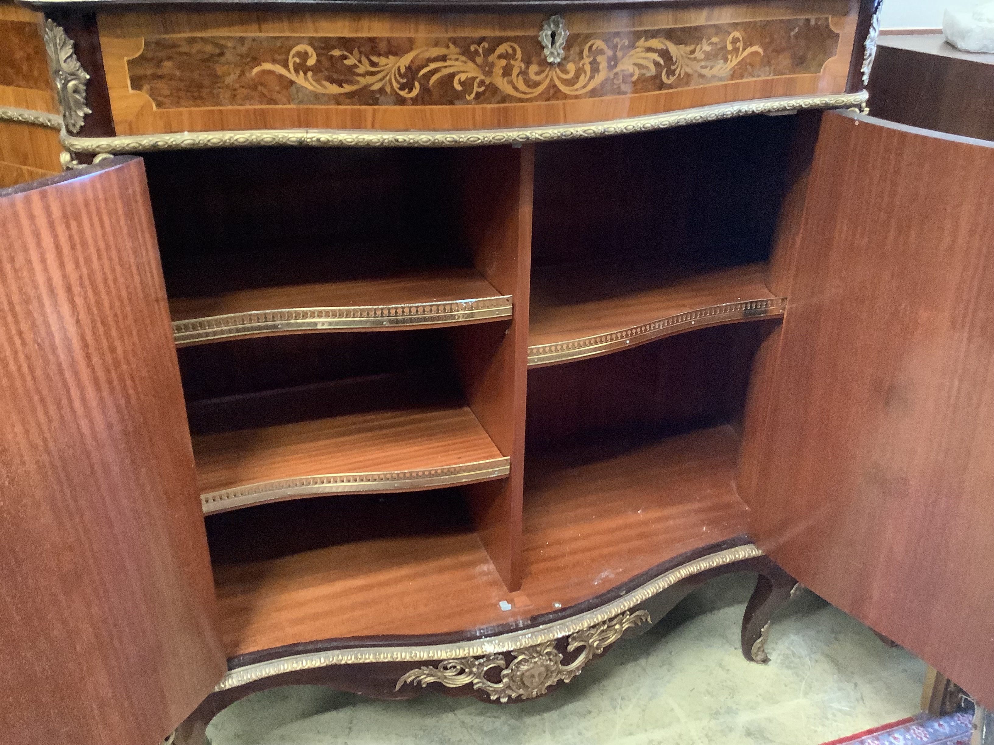 A Louis XV design walnut, kingwood and marquetry inlaid serpentine cabinet, length 116cm, depth 43cm, height 108cm